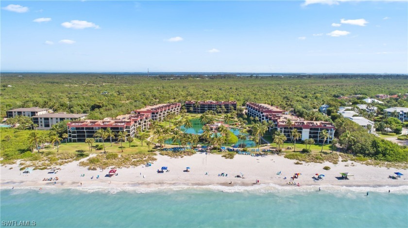 Palm trees, sugar sand, and blue gulf waters are all you see - Beach Condo for sale in Sanibel, Florida on Beachhouse.com