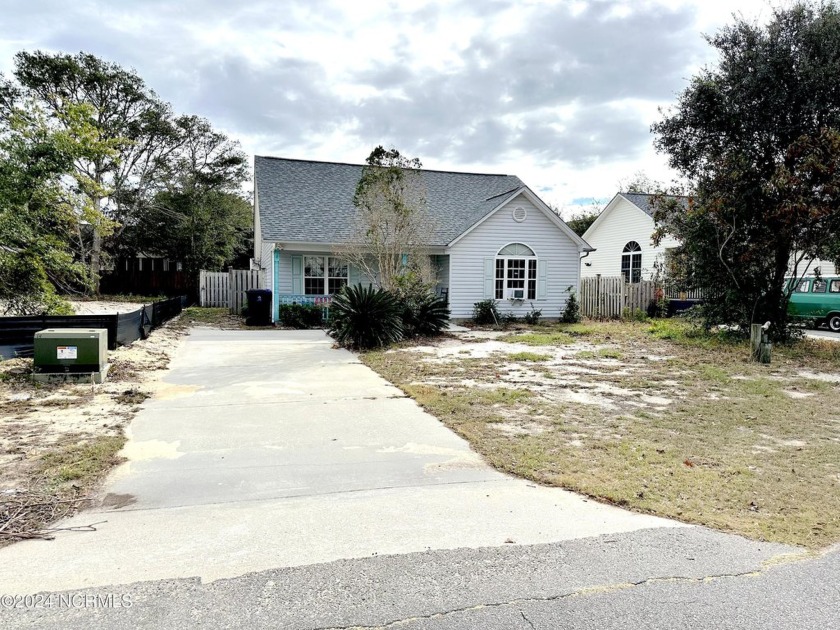 Discover the potential of this 2-bedroom, 2-bath, 889 sq. ft - Beach Home for sale in Oak Island, North Carolina on Beachhouse.com