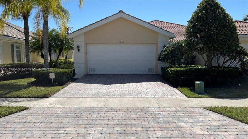 Beautiful waterfront villa featuring a screened-in pool and - Beach Home for sale in Wellington, Florida on Beachhouse.com