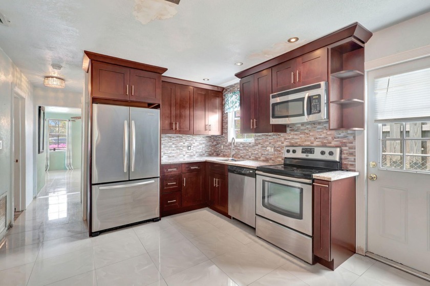 BEAUTIFUL SPACIOUS HOME WITH EAT-IN KITCHEN THAT BOASTS WOOD - Beach Home for sale in Riviera Beach, Florida on Beachhouse.com