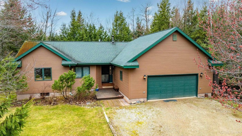 This inviting home sits on 110 feet of frontage along the - Beach Home for sale in L Anse, Michigan on Beachhouse.com