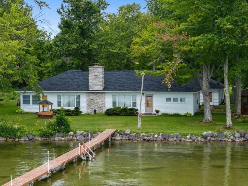 Located on the west shore of Burt Lake on 245 ft of frontage and - Beach Home for sale in Brutus, Michigan on Beachhouse.com