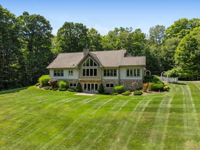 Nestled on a private 40-acre wooded parcel, this stunning home - Beach Home for sale in Charlevoix, Michigan on Beachhouse.com