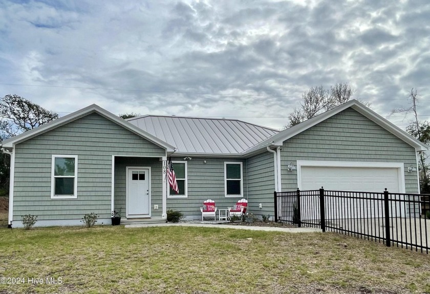 Nestled in the Maritime Forest, this home offers a metal roof - Beach Home for sale in Pine Knoll Shores, North Carolina on Beachhouse.com