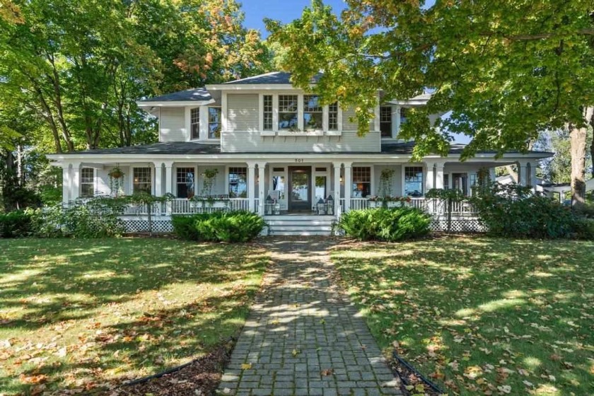 Offering turn-of-the-century charm, this historic Charlevoix - Beach Home for sale in Charlevoix, Michigan on Beachhouse.com