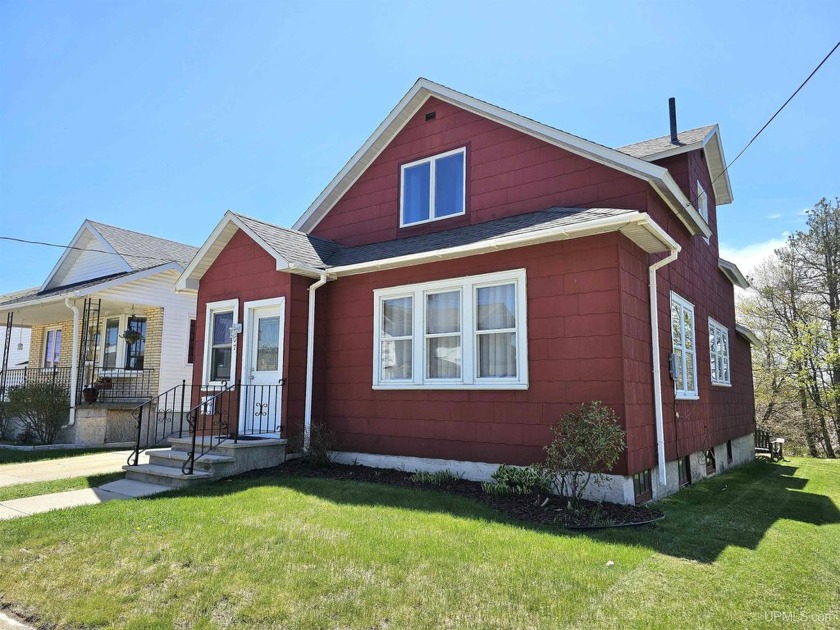 Charming and full of character, this two-story home is nestled - Beach Home for sale in Manistique, Michigan on Beachhouse.com