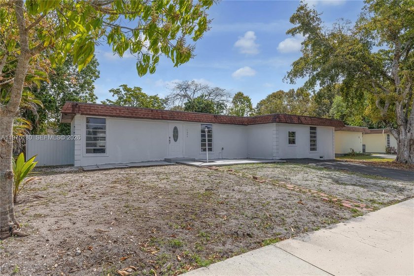 THREE BEDROOM,TWO BATH POOL HOME, WITH A GLASS ENCLOSED PORCH - Beach Home for sale in Tamarac, Florida on Beachhouse.com