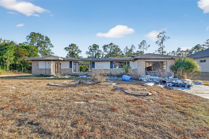 Investor Special in Lehigh Acres! Fire-damaged home situated on - Beach Home for sale in Lehigh Acres, Florida on Beachhouse.com