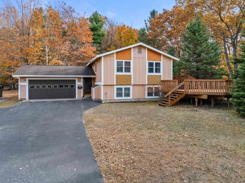 Classic bi-level looking over the 6th fairway of the Charlevoix - Beach Home for sale in Charlevoix, Michigan on Beachhouse.com