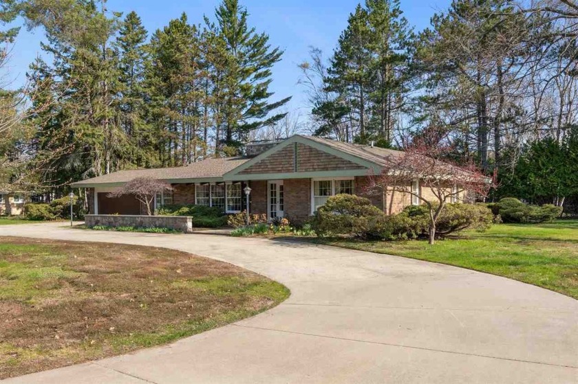 This ranch-style home in Charlevoix, MI, is ideally situated on - Beach Home for sale in Charlevoix, Michigan on Beachhouse.com