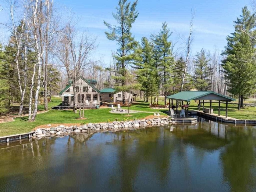 Located on the Crooked River close to Burt Lake.  This - Beach Home for sale in Brutus, Michigan on Beachhouse.com