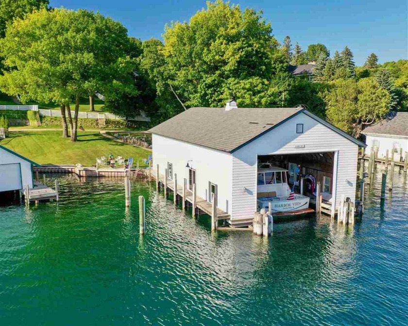 THIS CHARLEVOIX WATERFRONT HOME AND BOATHOUSE OFFERS an - Beach Home for sale in Charlevoix, Michigan on Beachhouse.com