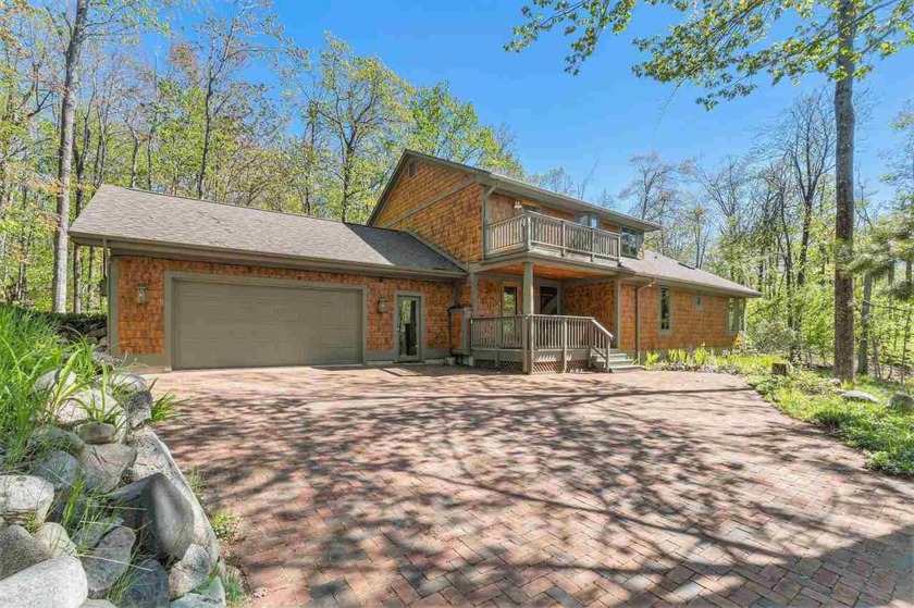 Perched at the crest of a wooded hill, this distinctive - Beach Home for sale in Harbor Springs, Michigan on Beachhouse.com