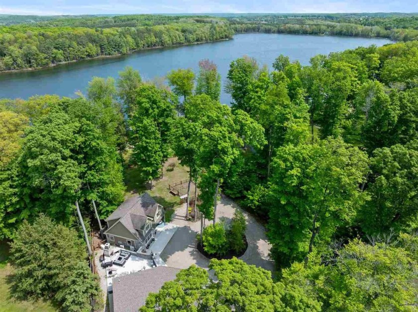 Nestled on nearly 1.5 acres of secluded waterfront, this - Beach Home for sale in Alden, Michigan on Beachhouse.com