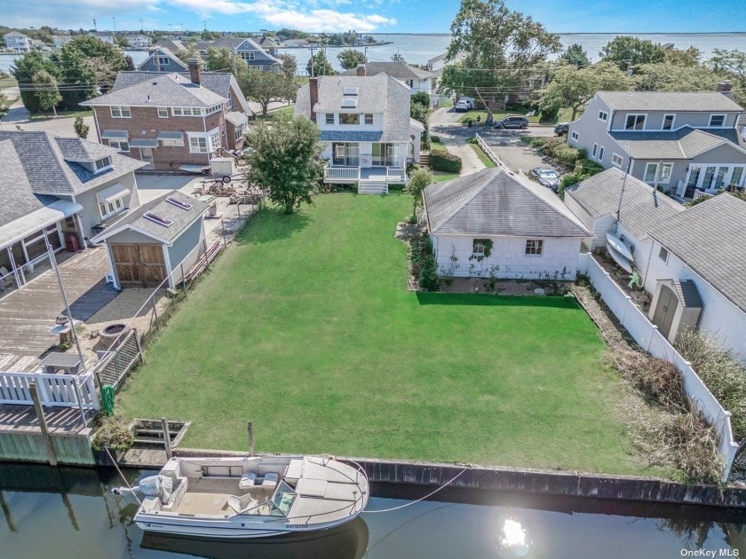 Embrace the potential of this waterfront gem with stunning water - Beach Home for sale in Amityville, New York on Beachhouse.com