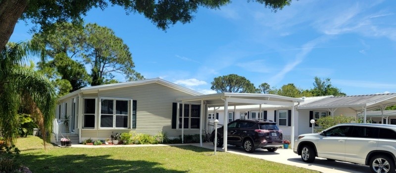 This nicely updated partially furnished 3-bedroom home sits on a - Beach Home for sale in Barefoot Bay, Florida on Beachhouse.com