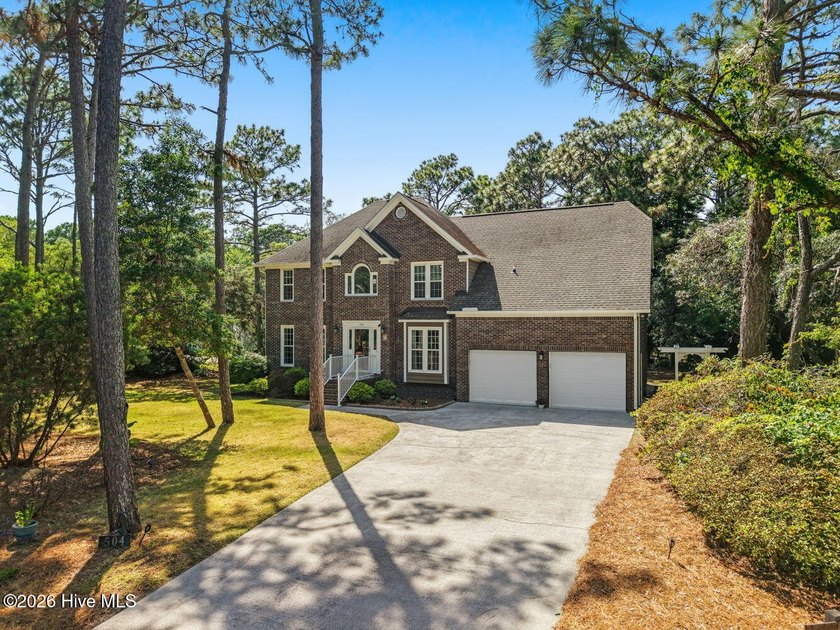 Tucked beneath a canopy of mature trees in the beautiful - Beach Home for sale in Caswell Beach, North Carolina on Beachhouse.com