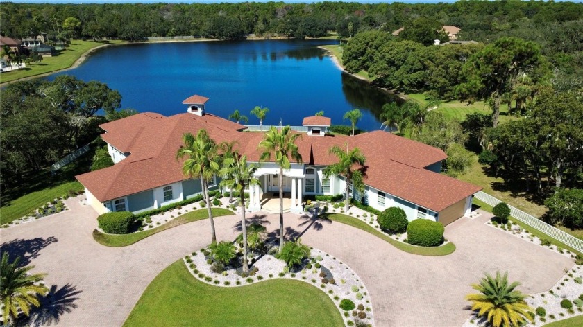 Welcome to this stunning lakefront estate on nearly an acre of - Beach Home for sale in Spring Hill, Florida on Beachhouse.com