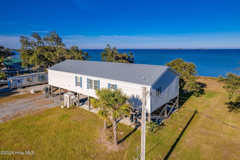 Discover the coastal charm of 415 Lola Road, a fully furnished - Beach Home for sale in Cedar Island, North Carolina on Beachhouse.com