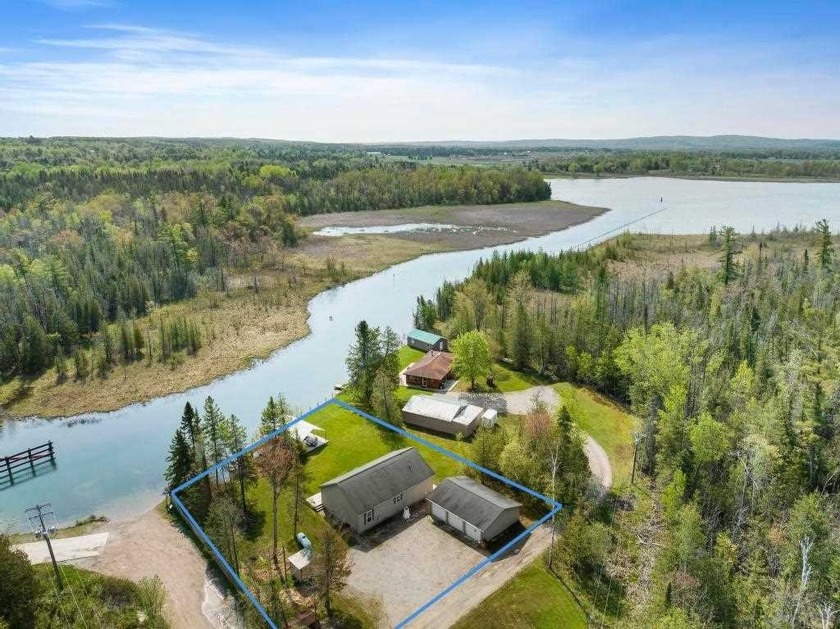 Located just north of Crooked Lake on Crooked River is this 3 - Beach Home for sale in Alanson, Michigan on Beachhouse.com