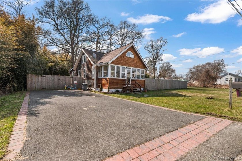Welcome to this charming and versatile single-family home - Beach Home for sale in Mastic Beach, New York on Beachhouse.com