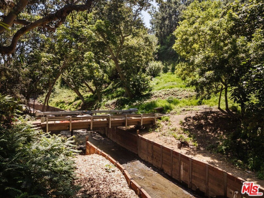 Tucked behind a private bridge where the creek flows beneath a - Beach Lot for sale in Santa Monica, California on Beachhouse.com