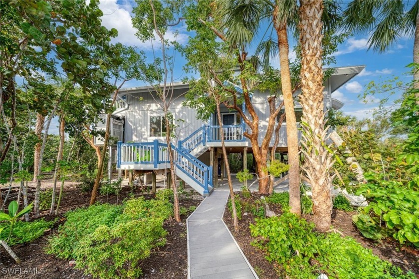 Immerse yourself in nature in this elevated 4-bedroom home on - Beach Home for sale in Sanibel, Florida on Beachhouse.com