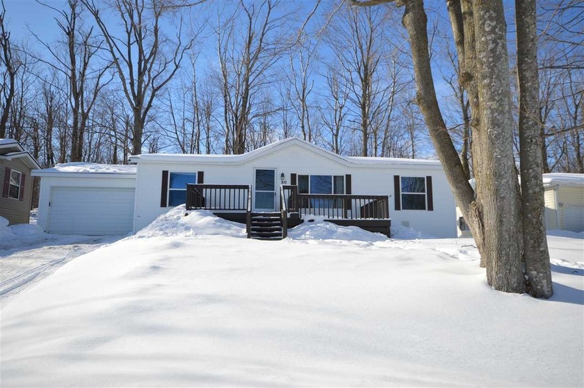 Discover this inviting 3-bedroom, 2-bath home in scenic - Beach Home for sale in Charlevoix, Michigan on Beachhouse.com