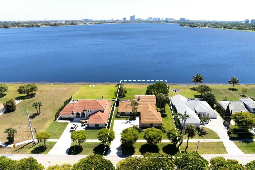 Beautiful Home on Lake Mangonia. Family Room & Kitchen Sliders - Beach Home for sale in West Palm Beach, Florida on Beachhouse.com