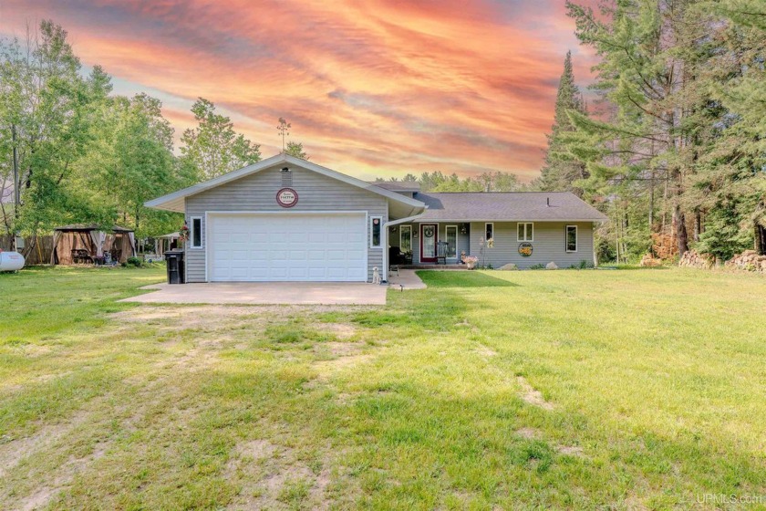 Tucked away on 137 feet of the beautiful Indian River in the - Beach Home for sale in Manistique, Michigan on Beachhouse.com