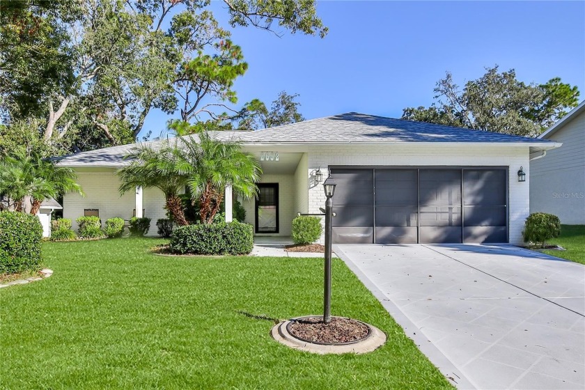 Welcome to this charming 2-bedroom, 2-bathroom home with a 2-car - Beach Home for sale in Spring Hill, Florida on Beachhouse.com