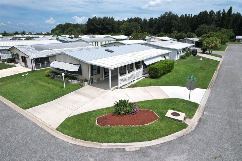 Corner lot with metal roof and circular drive leads to this - Beach Home for sale in Barefoot Bay, Florida on Beachhouse.com