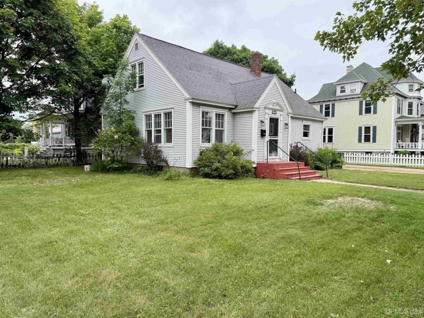 Welcome to this charming 1.5-story Cape Cod situated just two - Beach Home for sale in Escanaba, Michigan on Beachhouse.com