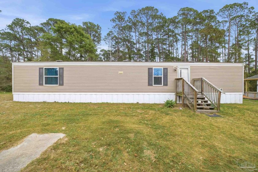 Welcome to this charming 2-bedroom, 2-bathroom home situated on - Beach Home for sale in Navarre, Florida on Beachhouse.com