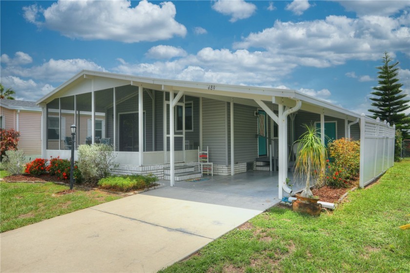 Attractive furnished home boasts of a screen porch stretching - Beach Home for sale in Barefoot Bay, Florida on Beachhouse.com