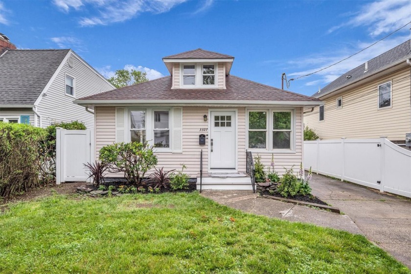 Nestled along a serene canal, this enchanting waterfront retreat - Beach Home for sale in Baldwin Harbor, New York on Beachhouse.com