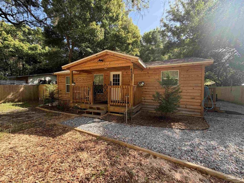 This charming log cabin-style cottage offers the perfect blend - Beach Home for sale in Milton, Florida on Beachhouse.com