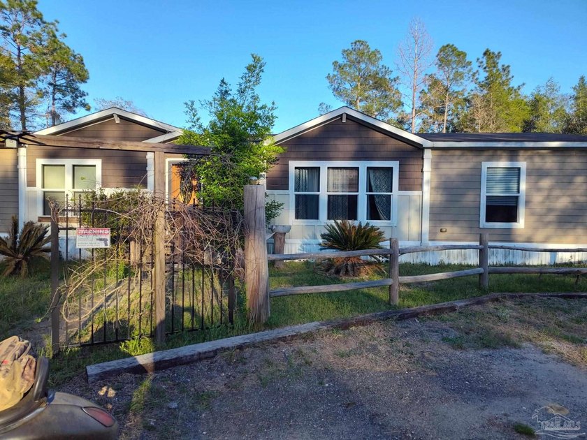 Welcome to this charming single-family home located at 7488 Wild - Beach Home for sale in Milton, Florida on Beachhouse.com
