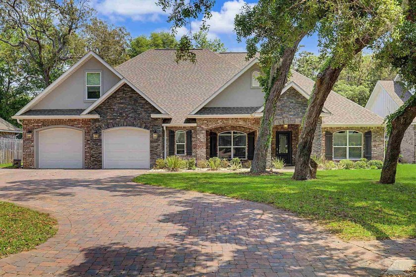 Welcome to this stunning custom-built home located in the gated - Beach Home for sale in Gulf Breeze, Florida on Beachhouse.com