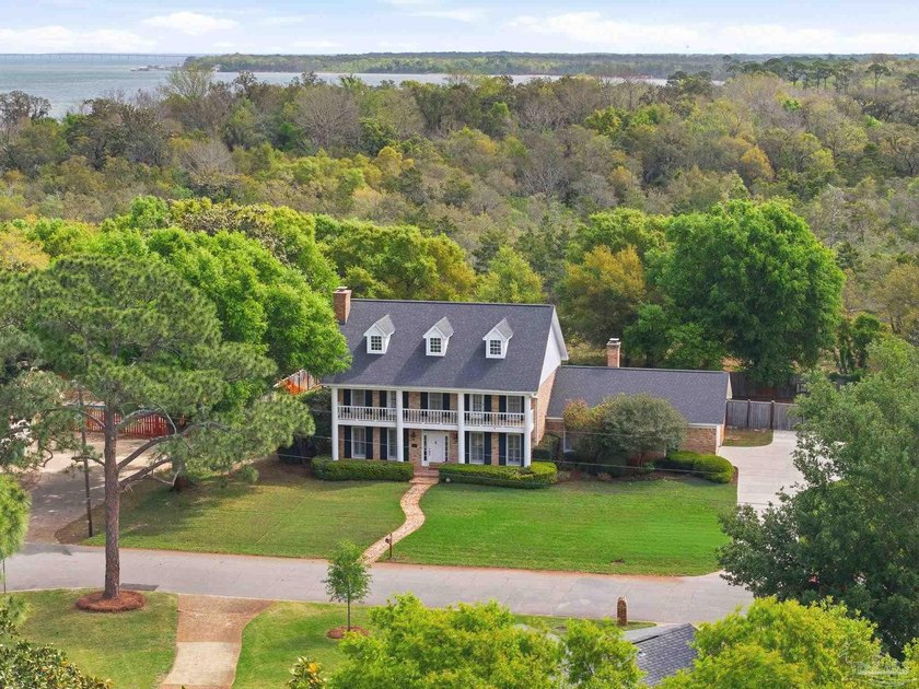 This stately 4-bedroom, 3-bath colonial sits at the center of - Beach Home for sale in Gulf Breeze, Florida on Beachhouse.com