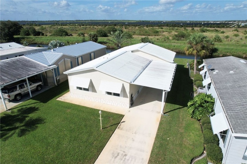 The home boasts a private backyard with a triple wide layout - Beach Home for sale in Barefoot Bay, Florida on Beachhouse.com