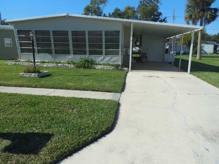 Nestled in a beautifully maintained 55+ manufactured home park - Beach Home for sale in Port Orange, Florida on Beachhouse.com