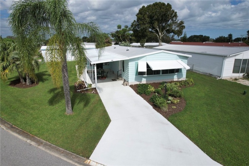 Coastal style home features metal roof & newer A/C. Situated on - Beach Home for sale in Barefoot Bay, Florida on Beachhouse.com