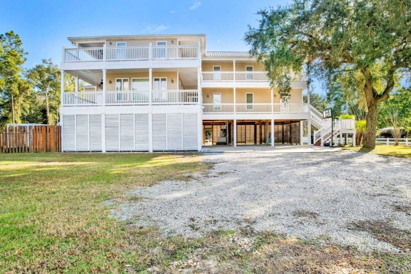 Discover coastal living at its finest in this inviting 5-bedroom - Beach Home for sale in Gulf Shores, Alabama on Beachhouse.com