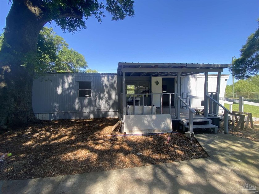 This corner lot property includes a mobile home featuring 2 - Beach Home for sale in Pensacola, Florida on Beachhouse.com