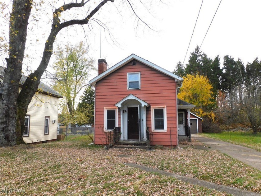 This charming home features a spacious living room adorned with - Beach Home for sale in Conneaut, Ohio on Beachhouse.com