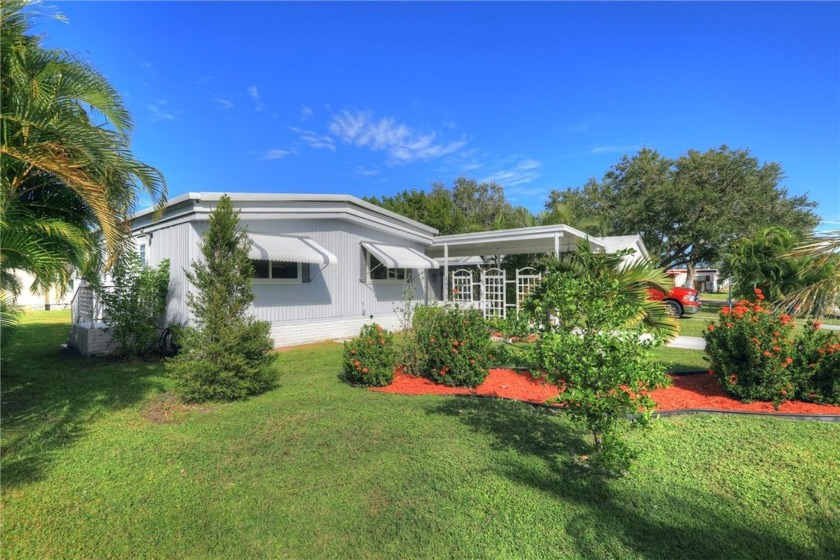 COME HOME TO BAREFOOT BAY.... This beautifully landscaped home - Beach Home for sale in Barefoot Bay, Florida on Beachhouse.com