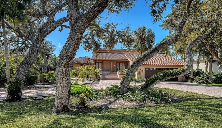 Wrapped in lush, mature landscaping and set along a tranquil - Beach Home for sale in Longboat Key, Florida on Beachhouse.com