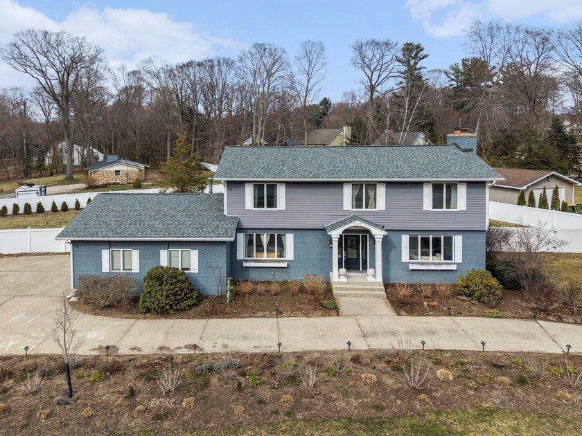 Welcome to this beautifully designed 4-bedroom, 3-bath residence - Beach Home for sale in Grand Haven, Michigan on Beachhouse.com