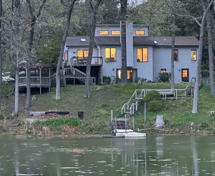 Located on a slight bluff overlooking Stearns Bayou, this four - Beach Home for sale in Grand Haven, Michigan on Beachhouse.com